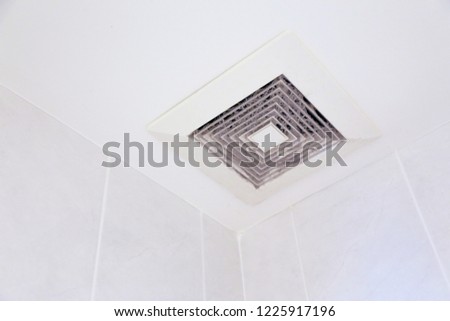 sticky and dirty full of dust exhaust ventilation fan on ceiling with copy space