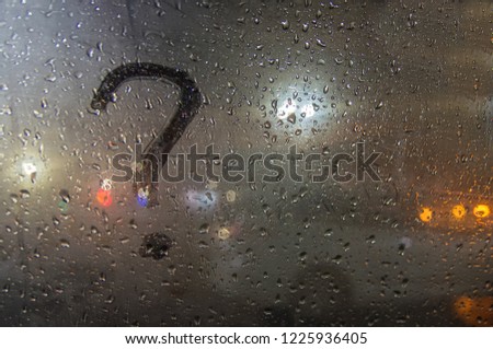 Autumn rain, the inscription on the sweaty glass - question mark