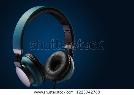 expensive blue headphone on dark background. advertising photography
