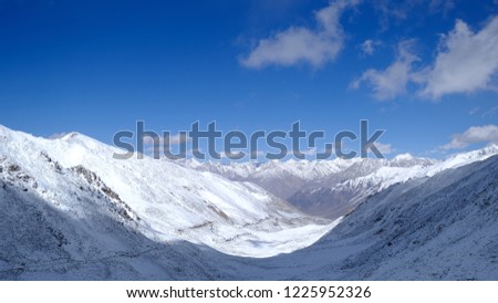 Snowy mountains under bright blue sky