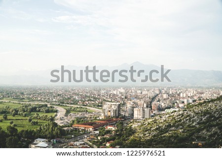 Horizontal picture of an overview of Shköder, Albania, Europe. Picture taken from a hill with an overview of the city and the mountains that surround it.