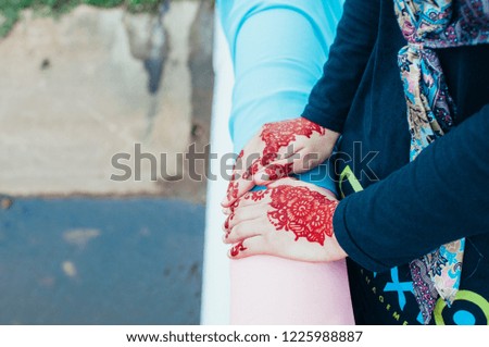 Female hands with henna tattoo  