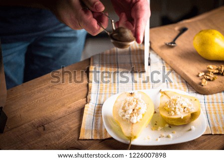 Backstage. The hands of the photographer in the frame powdered cinnamon pears. Creating a photo