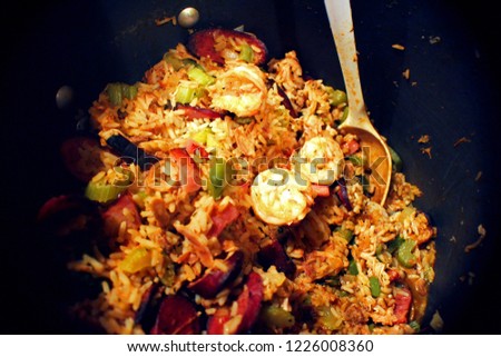 A close up photograph looking into a big pot full of jambalaya, possibly the most iconic Cajun dish.
