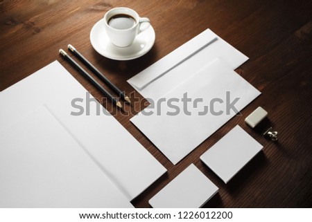 Photo of blank corporate stationery on wooden background. Branding mock-up.