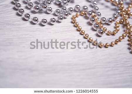 Silver and gold beads on a white background