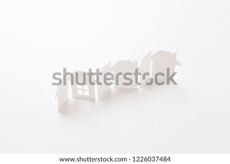 row linked of paper cutout houses with detail one on white background, for home and banking conceptual, selective focused.