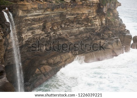 In the picture on top left position. The young guy sit on the cliff locate in Eagle rock royal national park ( Australia )