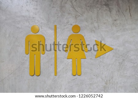 Bathroom Icon Sign (Restroom or Toilet room) on the cement wall