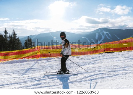 Teenager is skiing at a ski resort in the mountains