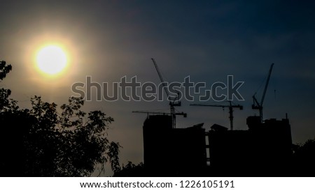 Under construction building with the sun. Silhouette picture.