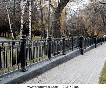 walkway and fence in autumn park