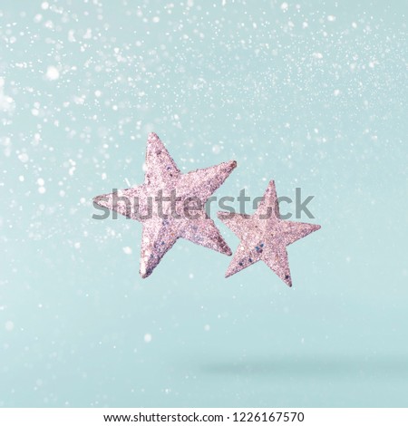 Christmas concept.  Creative Christmas conception made by falling in air silver stars over blue background. Minimal concept