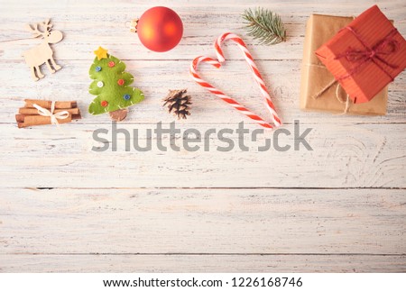 Christmas background. Frame made by a lot of christmas stuff like baubles, toys and decorations over wooden board. Chrismas concept