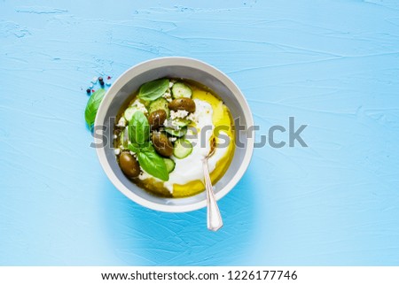 Greek yogurt, olives, feta cheese, cucumber, olive oil and basil flat lay