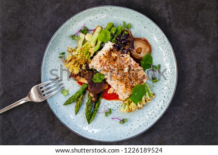 Halibut with hazelnut crust with roast red pepper sauce, asparagus, cauliflower and shiitake mushrooms