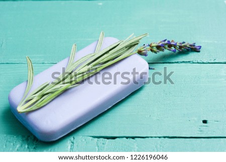 lavender soap and flowers on worn blue painted wooden table background