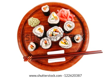 Maki Sushi : Maki Rolls and California rolls made of fresh raw Salmon(sake), Tuna(maguro) and Eel(unagi) . on wooden plate with wasabi and ginger isolated over white background