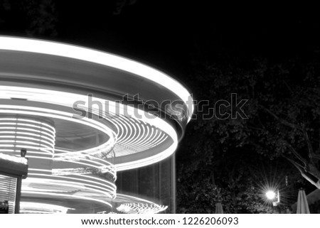 funfair ride picture, long exposure lights with rotational effect, black and white