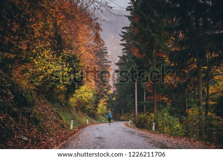 Active outdoor sport photo. Athlete running in autumn forest