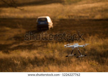 Flying drone in flight over a beautiful meadow  
