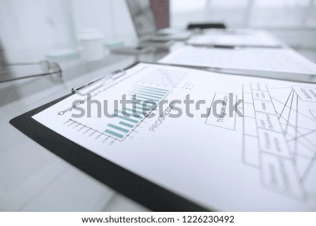 financial chart about the report on the glass table in the office