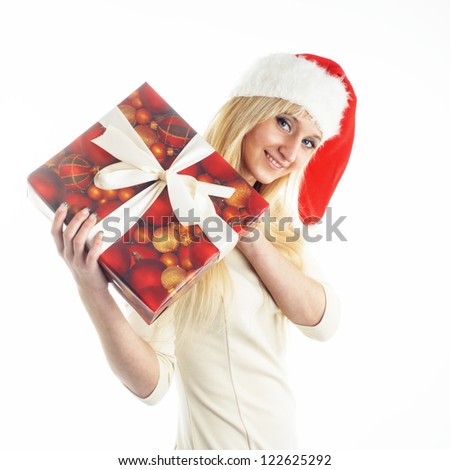 Picture of pretty christmas girl in santa hat, smiling and hold christmas gift.Isolated on white background