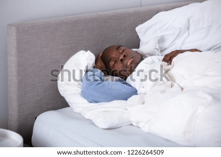 Photo Of Young African Man Sleeping On Bed