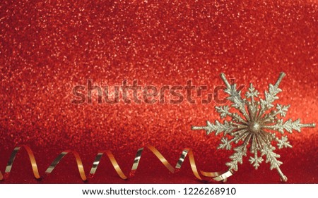 Christmas red background. New year decoration. Vintage golden snowflake and ribbon. Bokeh defocused light effect