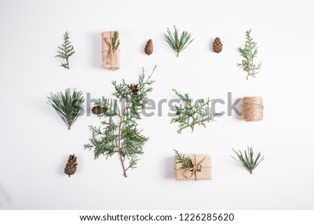 Christmas composition. Gift, christmas decoration, cypress branches, pine cones on white background