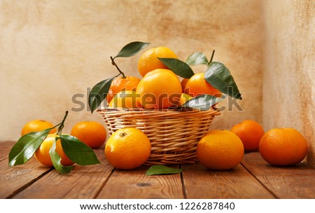 Fresh mandarin oranges fruit or tangerines with leaves on wooden table Royalty-Free Stock Photo #1226287840