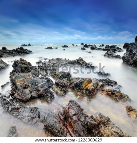 long exposure of misty sea and rocks, selective focus.Nature composition. A slow shutter speed was used to see the movement'
