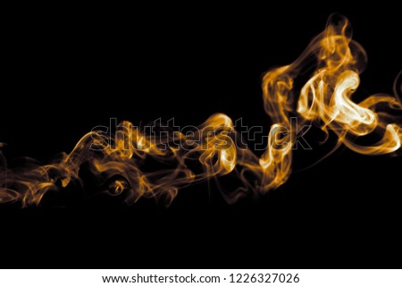 Beauty gold smoke on dark free  background, Soft movement glitter fire flame, Abstract and texture of amazing magic golden natural cloud on black background. light effect for creative and design.