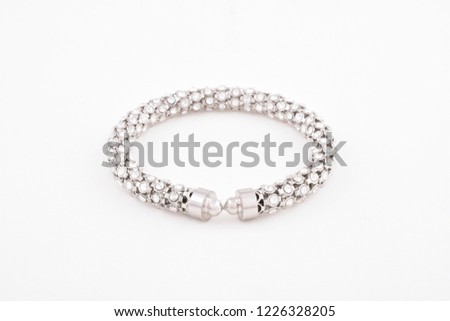 Simple stylish silver or platinum diamond bracelet or bangle on white background
