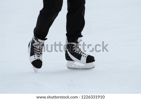 Close-up of ice skater's male feet on ice rink during ice hockey. winter sport. Activity of the cold season