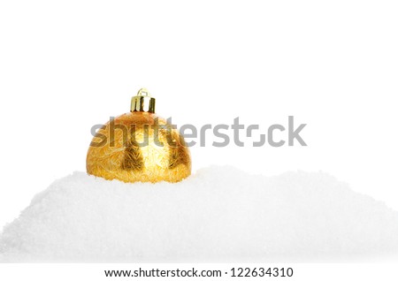 Closeup of a shiny gold glitter Christmas bauble with a decorative