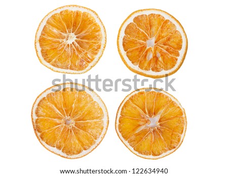 four dried slices of orange isolated on white background Royalty-Free Stock Photo #122634940