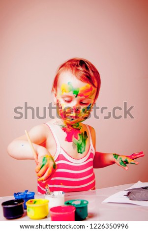 Cute little child girl painting a picture 