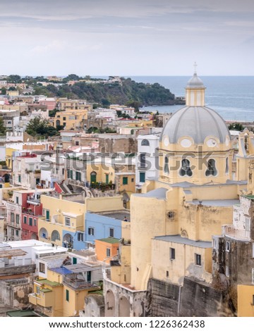 Marina Corricella, colourful fishing village on the island of Procida in the Bay of Naples, Italy. Photo taken from the top of the cliff. Church of Santa Maria della Pieta is visible on the right.