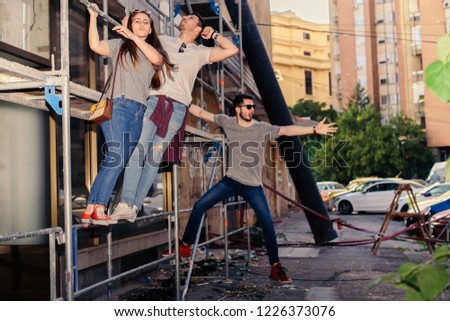 Carefree Friends Hiking On Construction Building. Young and careless