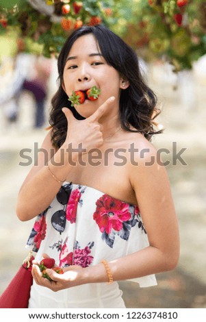 Young woman at a strawberry farm