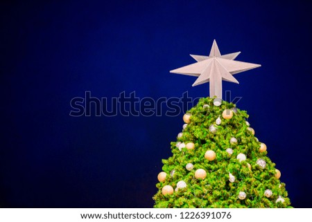 Star on top of Christmas tree and Christmas holiday background.
