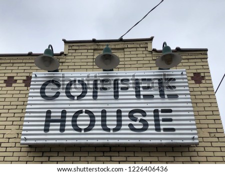 Modern metal Coffee house sign on brick background