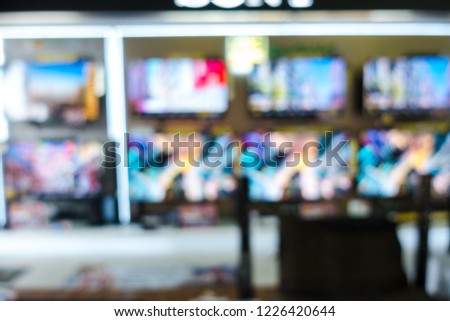 blurry background of home appliance shop in television department.