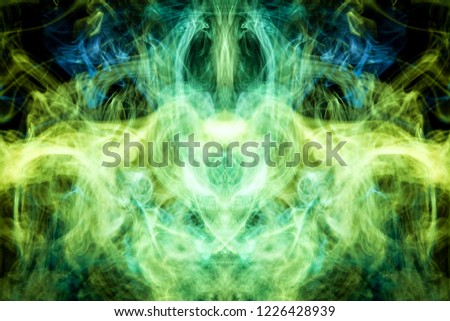Thick colorful green  and yellow smoke  in the form of a butterfly on a black isolated background. Background from the smoke of vape. Mocap for cool t-shirts

