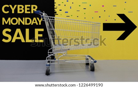 Cyber Monday with Sale Promotional Concept. Shopping Lifestyle. Empty Cart with Text and Arrow Direction on the Wall , ready for Customer to Pickup or Buying Products