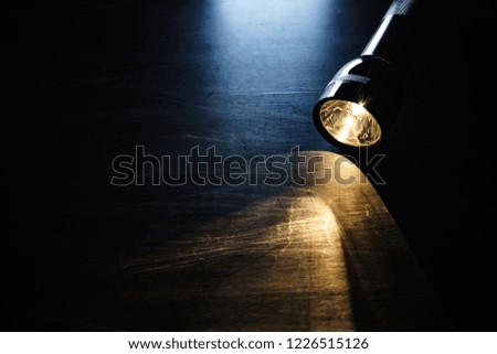 Flashlight on black background board
