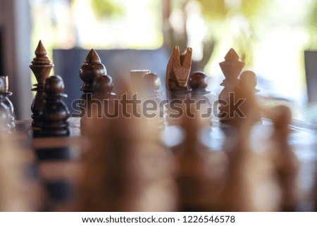 Closeup image of a wooden chess set on chessboard