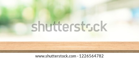 Wood table top and blur background for product and display montage banner size. Royalty-Free Stock Photo #1226564782