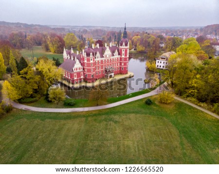Wonderful picturesque Scene in the Park. Muskau Castle with sky in autumn. Schloss of Saxony, Germany. UNESCO World Heritage Site. Beautiful castle. 